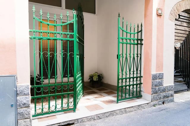 Green ornate gates open to exterior entrance exterior at Cosy double-bedroom apartment in Albenga (SV) in Albenga Student Accommodation