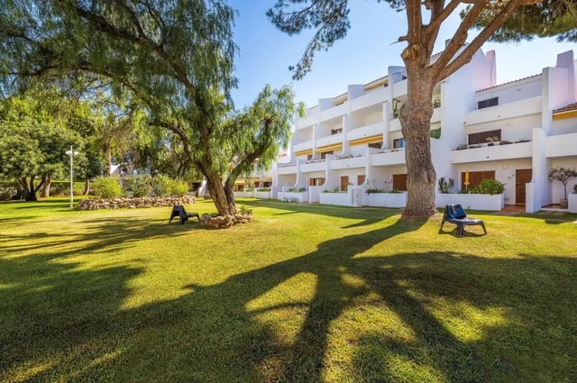 White building with balconies green lawn exterior at Luxurious 1-bedroom apartment in Vilamoura in Faro Student Accommodation
