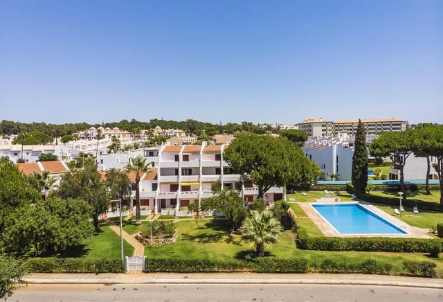 Apartments with pool and green lawn exterior at Luxurious 1-bedroom apartment in Vilamoura in Faro Student Accommodation