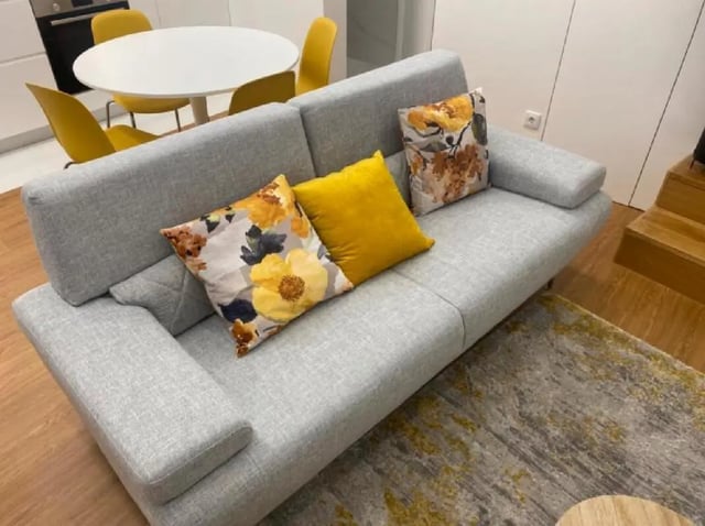 Sofa with patterned pillows and yellow pillow living room at Luxury 1 Bedroom Apartment close to  Polytechnic Institute of Viana do Castelo in Viana Do Castelo Student Accommodation