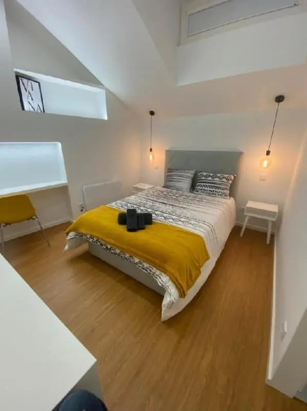 Bed with yellow blanket desk and chair bedroom at Luxury 1 Bedroom Apartment close to  Polytechnic Institute of Viana do Castelo in Viana Do Castelo Student Accommodation