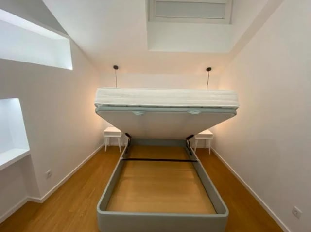 Wall bed with mattress two bedside tables bedroom at Luxury 1 Bedroom Apartment close to  Polytechnic Institute of Viana do Castelo in Viana Do Castelo Student Accommodation