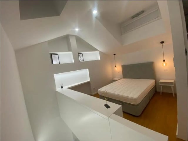 Bed with bedside tables hanging lamps bedroom at Luxury 1 Bedroom Apartment close to  Polytechnic Institute of Viana do Castelo in Viana Do Castelo Student Accommodation