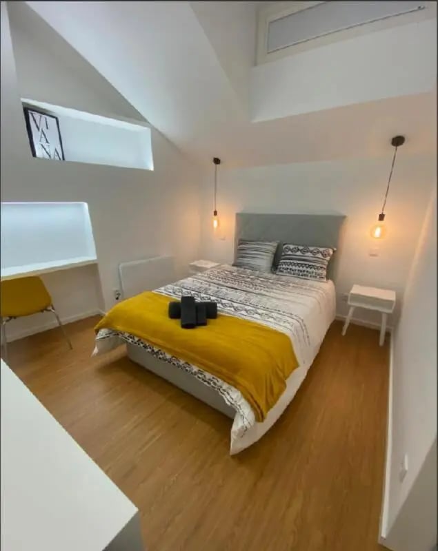 Bed study area yellow chair and desk bedroom at Luxury 1 Bedroom Apartment close to  Polytechnic Institute of Viana do Castelo in Viana Do Castelo Student Accommodation