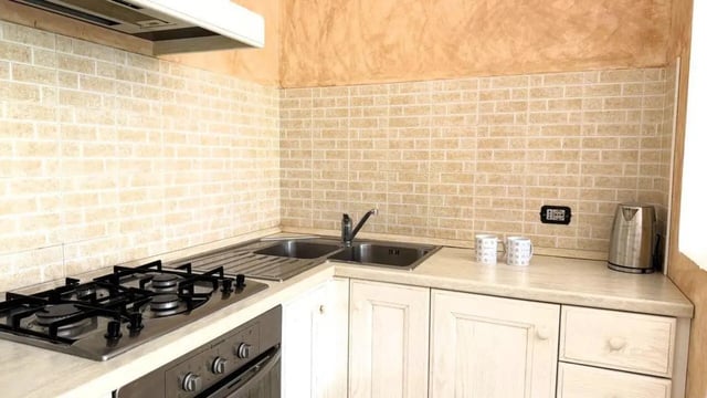 Gas hob sink mugs kettle kitchen at Tasteful 1-bedroom apartment in Albenga in Albenga Student Accommodation