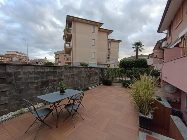 Patio with table chairs plant and buildings exterior at Comfy studio inside an indipendent house well connected to Università di Novara in Novara Student Accommodation
