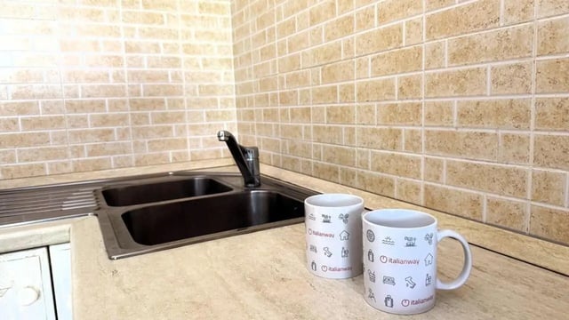 Sink faucet and mugs kitchen at Tasteful 1-bedroom apartment in Albenga in Albenga Student Accommodation