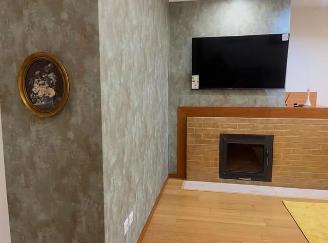 Painting TV fireplace and wood floor Living room at Exclusive 2 Bedroom Apartment with a balcony close to Minho University in Guimaraes Student Accommodation