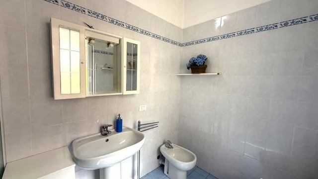 Sink bidet mirrored cabinet bathroom at Tasteful 1-bedroom apartment in Albenga in Albenga Student Accommodation