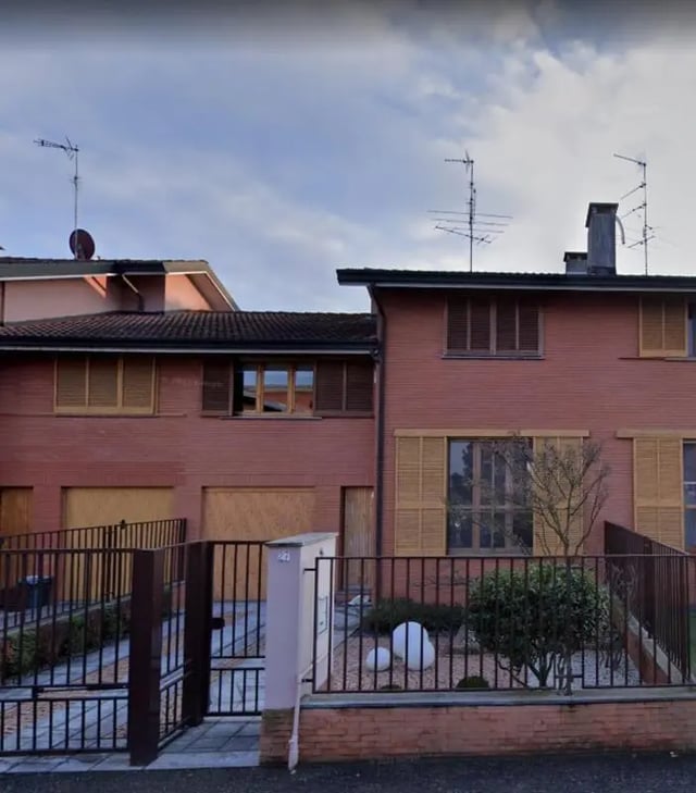 Red brick houses with fences and garden exterior at Comfy studio inside an indipendent house well connected to Università di Novara in Novara Student Accommodation