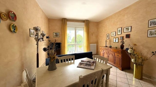 Table chairs sideboard window living room at Tasteful 1-bedroom apartment in Albenga in Albenga Student Accommodation