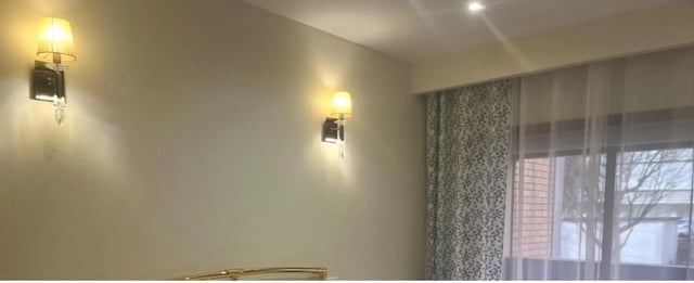 Two wall sconces and curtains in a bedroom at Exclusive 2 Bedroom Apartment with a balcony close to Minho University in Guimaraes Student Accommodation