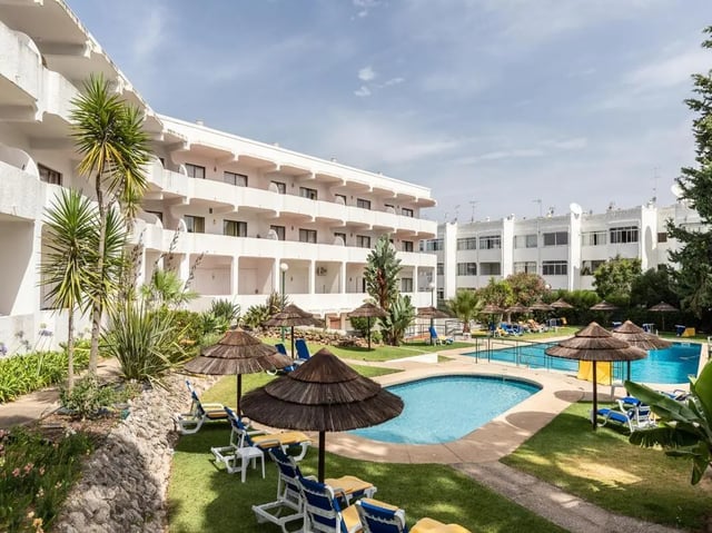 Resort buildings pools and lounge chairs exterior at Nice 1-bedroom flat in Faro in Faro Student Accommodation