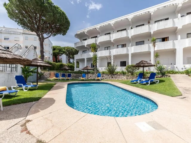 Pool with lounge chairs and apartment building exterior at Nice 1-bedroom flat in Faro in Faro Student Accommodation