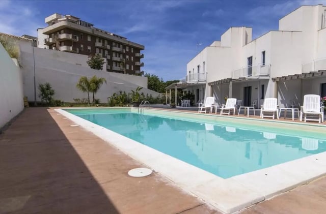 Swimming pool with lounge chairs exterior at Comfy Apartment close to the beach in Agrigento Student Accommodation