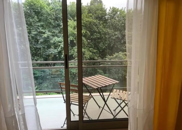 Balcony with table chairs and trees exterior at Exclusive 2 Bedroom Apartment with a balcony close to Minho University in Guimaraes Student Accommodation