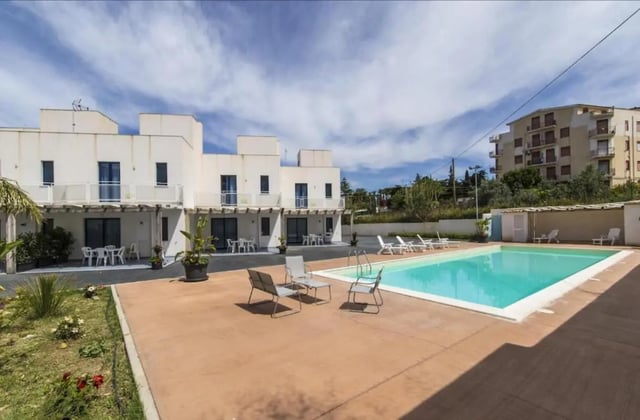 Apartment complex with pool and lounge chairs exterior at Comfy Apartment close to the beach in Agrigento Student Accommodation