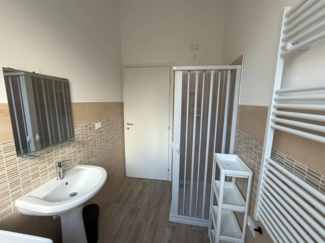 Sink mirror shower shelving towel rack bathroom at Amazing single room in Pescara in Pescara Student Accommodation