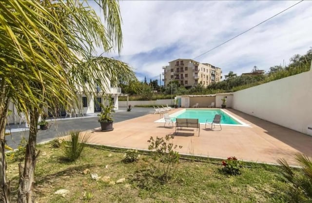 Pool area with lounge chairs and seating exterior at Comfy Apartment close to the beach in Agrigento Student Accommodation