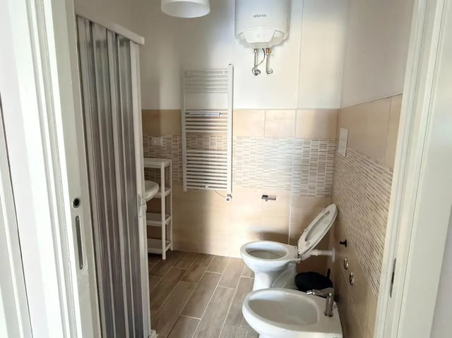 Toilet bidet sink shower curtain bathroom at Amazing single room in Pescara in Pescara Student Accommodation