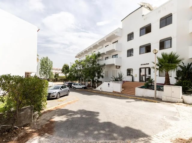 White building cars trees entrance exterior at Nice 1-bedroom flat in Faro in Faro Student Accommodation
