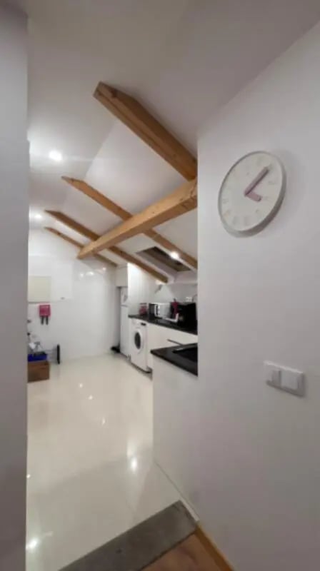Kitchen with washing machine and clock kitchen at Cozy Single Bedroom – Exclusively for IPVC Students, near Viana do Castelo Train Station in Viana Do Castelo Student Accommodation