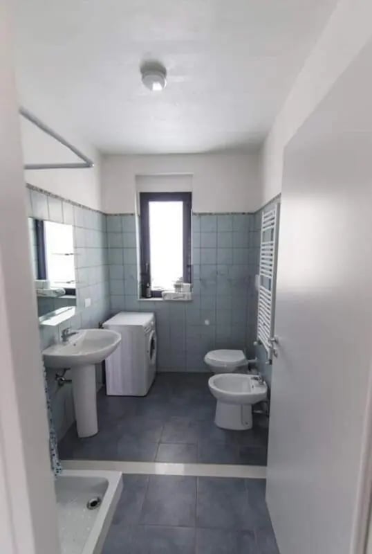 Sink washing machine toilet bidet bathroom at Comfy Apartment close to the beach in Agrigento Student Accommodation