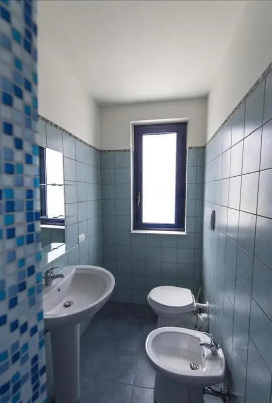 Sink bidet toilet window bathroom at Comfy Apartment close to the beach in Agrigento Student Accommodation
