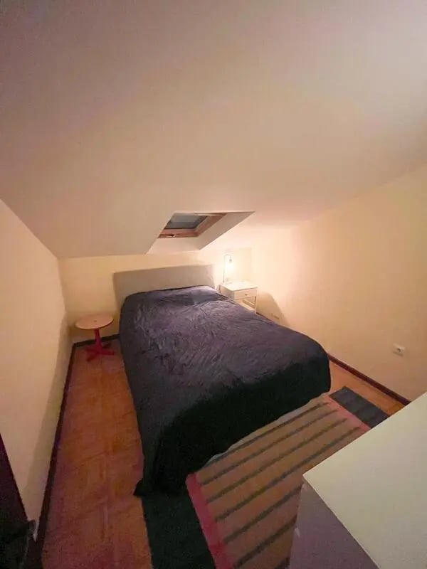 Bed nightstand table skylight bedroom at Beachfront Loft in Viana Do Castelo Student Accommodation