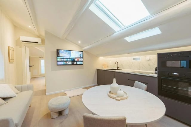 Modern kitchen dining area with television living room at Charming 1-bedroom apartment near Pescara Centrale in Pescara Student Accommodation