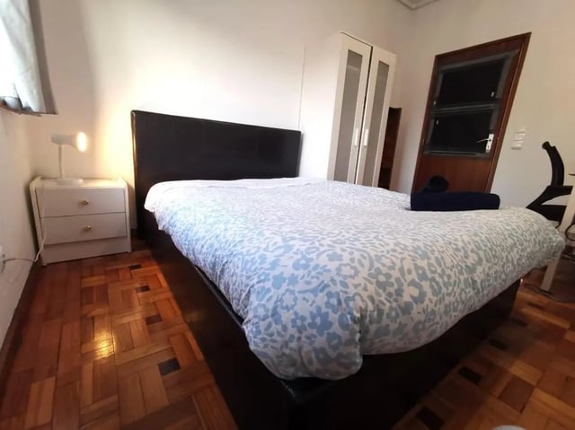 Bed nightstand lamp closet door bedroom at Double Bedroom close to Minho University 8 in Guimaraes Student Accommodation