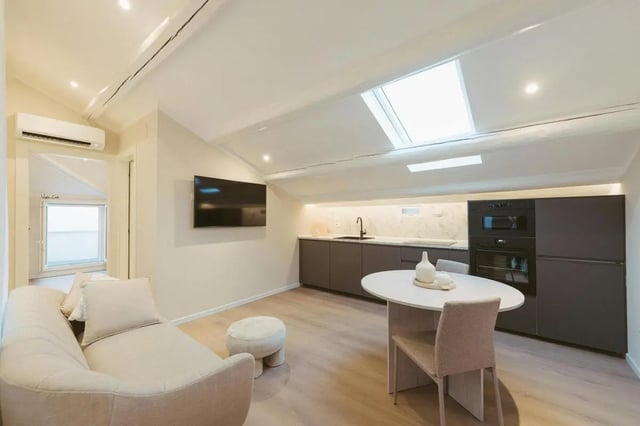 Sofa television kitchen island and oven living room at Charming 1-bedroom apartment near Pescara Centrale in Pescara Student Accommodation