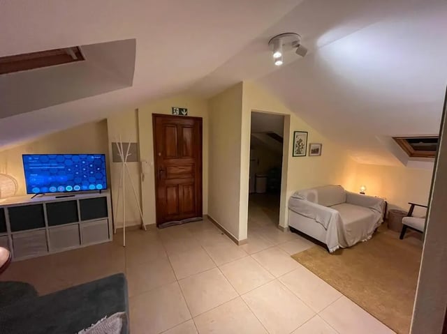TV couch and door living room at Beachfront Loft in Viana Do Castelo Student Accommodation