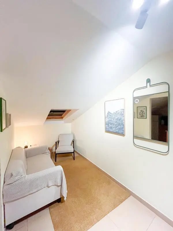 Sofa chair artwork mirror living room at Beachfront Loft in Viana Do Castelo Student Accommodation