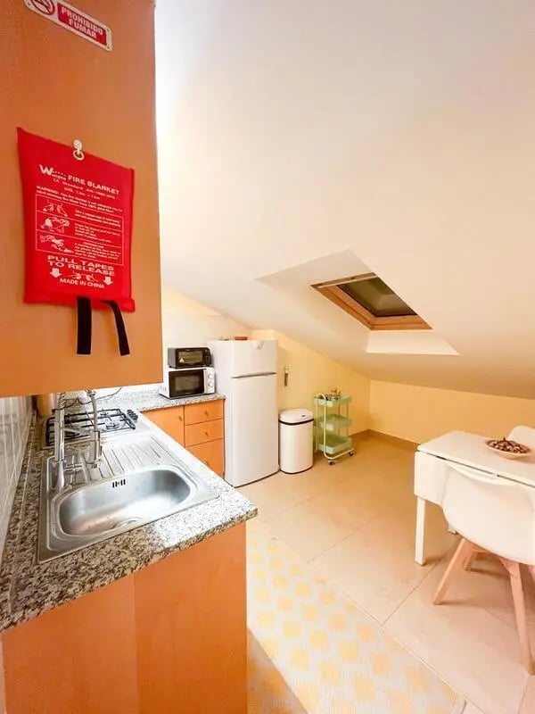 Sink hob microwave fridge and table kitchen at Beachfront Loft in Viana Do Castelo Student Accommodation