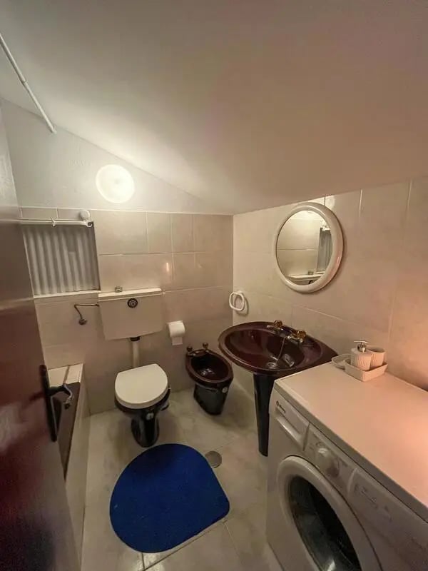 Toilet bidet sink washing machine bathroom at Beachfront Loft in Viana Do Castelo Student Accommodation