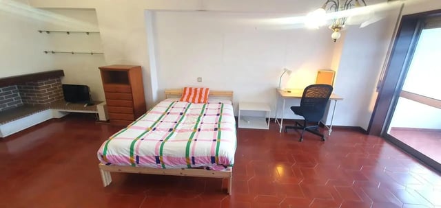 Bed dresser desk chair television fireplace bedroom at Double Bedroom close to Minho University 8 in Guimaraes Student Accommodation