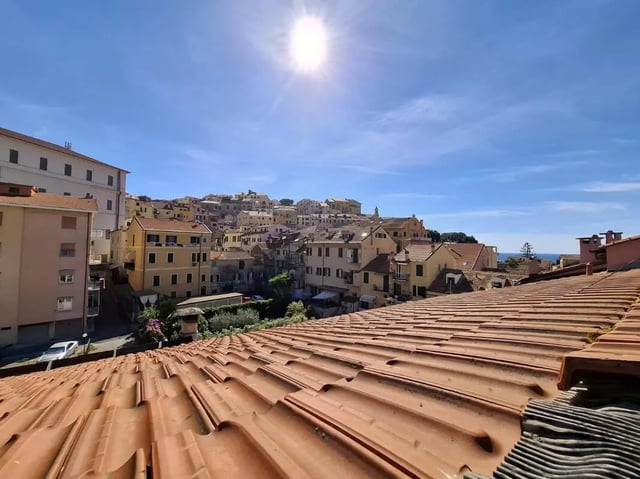 Terracotta tiled roofs overlook town buildings exterior at Apartment with Terrace in Imperia in Imperia Student Accommodation