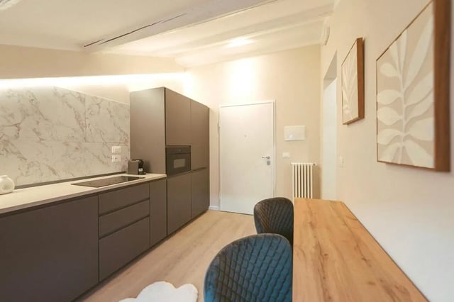 Modern grey kitchen with dining area Kitchen at Elegant 1-bedroom apartment near Pescara Centrale in Pescara Student Accommodation