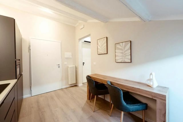 Kitchen dining area with two chairs and table at Elegant 1-bedroom apartment near Pescara Centrale in Pescara Student Accommodation