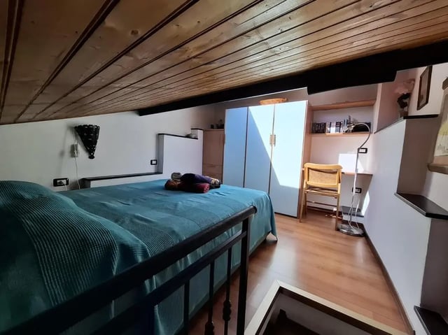 Bed wardrobe desk chair and shelves bedroom at Apartment with Terrace in Imperia in Imperia Student Accommodation