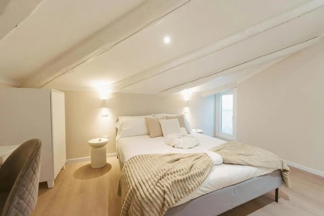 White bed with throw and side table bedroom at Elegant 1-bedroom apartment near Pescara Centrale in Pescara Student Accommodation