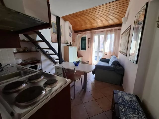 Kitchen table sofa and stairs living room at Apartment with Terrace in Imperia in Imperia Student Accommodation