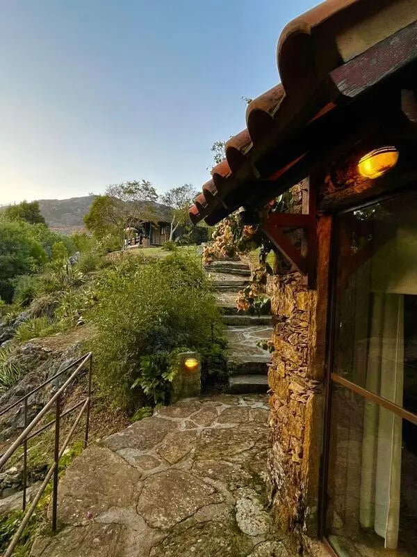 Stone pathway leading to rustic building exterior at Charming and serene country house in Sopo, Vila Nova de Cerveira in Viana Do Castelo Student Accommodation