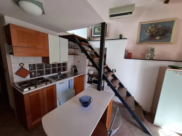 Kitchenette with stairs dining table kitchen Image Type at Apartment with Terrace in Imperia in Imperia Student Accommodation