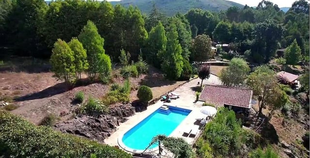 Blue swimming pool with lounge chairs exterior at Charming and serene country house in Sopo, Vila Nova de Cerveira in Viana Do Castelo Student Accommodation