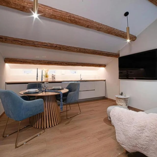Dining table chairs modern kitchen living area at Inviting 1-bedroom apartment near Pescara Centrale in Pescara Student Accommodation