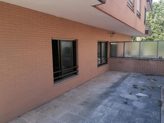 Patio with brick wall and windows exterior at Cozy Single Bedroom close to Lavandeira Park in Vila Nova De Gaia Student Accommodation