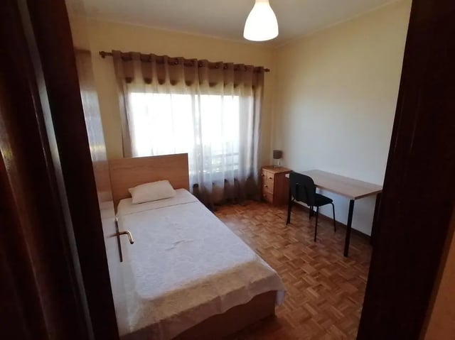 Bed desk chair lamp and window Bedroom at Cozy Single Bedroom close to Lavandeira Park in Vila Nova De Gaia Student Accommodation