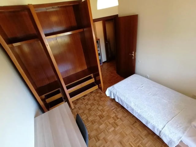 Wardrobe desk bed and open door bedroom at Cozy Single Bedroom close to Lavandeira Park in Vila Nova De Gaia Student Accommodation